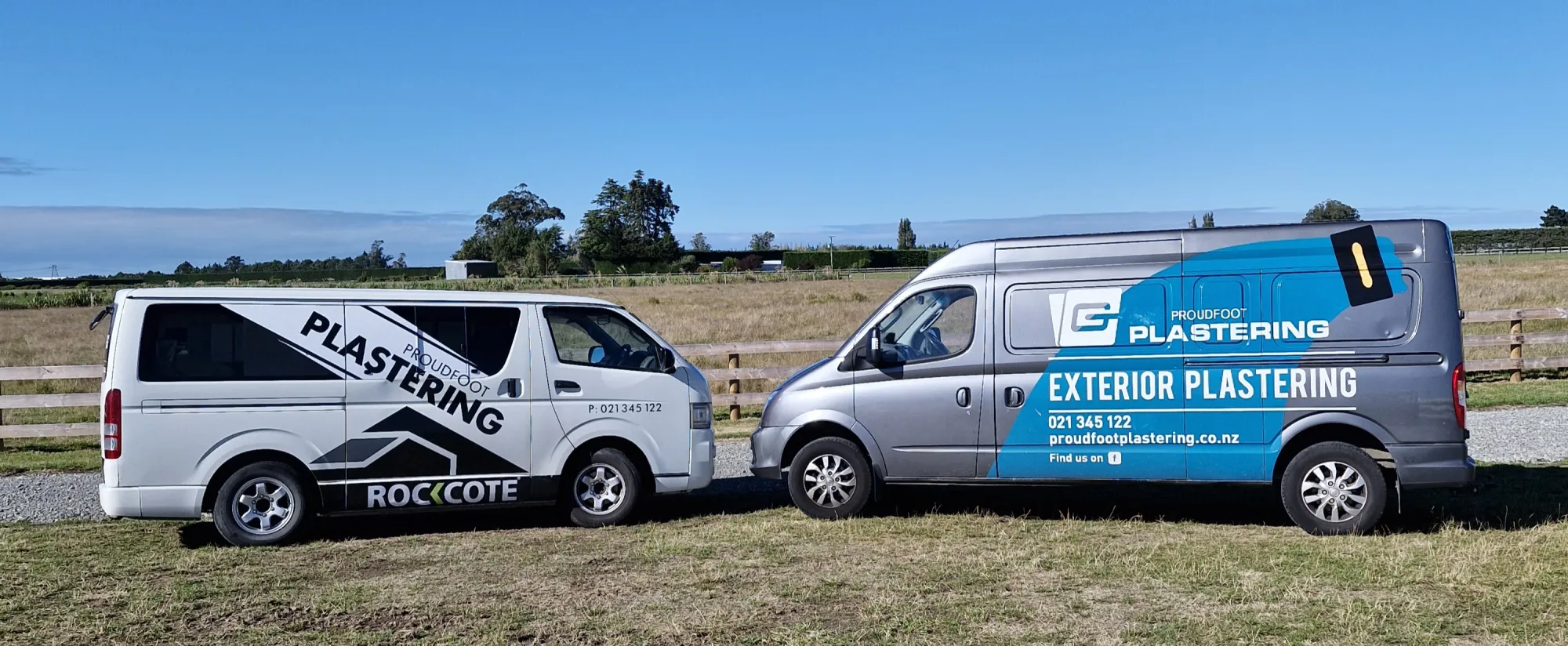 Two branded Proudfoot Plastering vans parked in a rural Canterbury field
